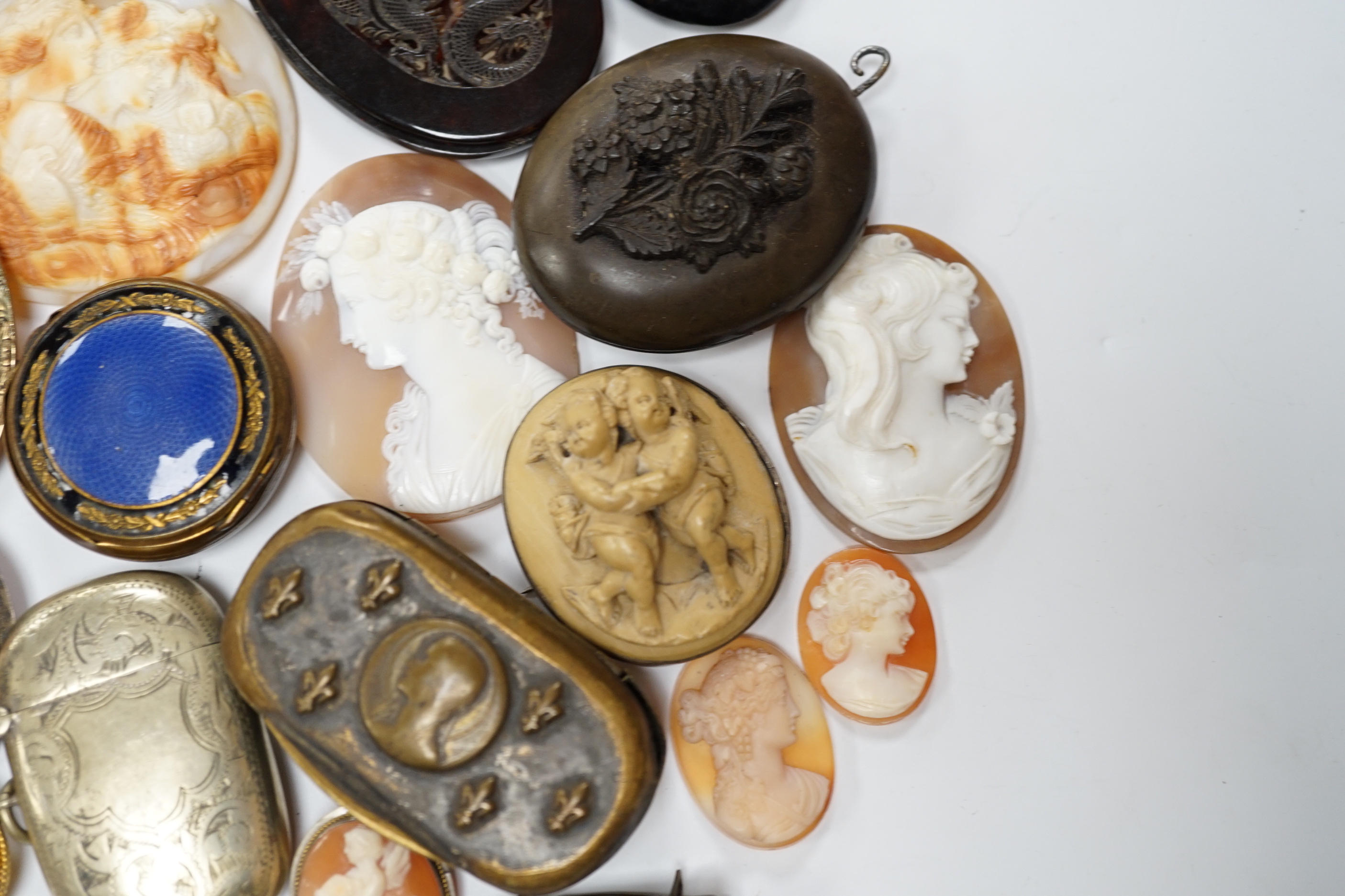 Five assorted unmounted carved cameo shells, largest 57mm, four other mounted cameo brooches including three shell, two base metal vestas and a box and sundry other items.